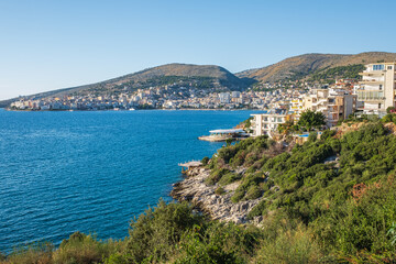 Naklejka na ściany i meble Saranda. Albania. Panorama of the city. Promenade. City Port. City beach. The Ionian Sea. Albanian Riviera.