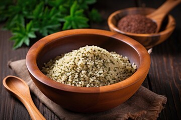 Obraz na płótnie Canvas cooked quinoa in an earthen bowl with a wooden spoon