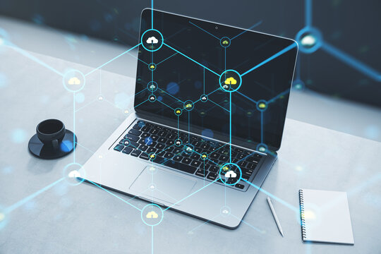 Close up of laptop on desk with coffee cup, notepad and creative glowing hexagonal pattern with tiny padlocks on blurry background. Digital security and firewall concept. Double exposure.