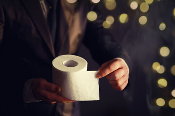 Businessman Holding a pile of Toilet Paper, copy space. Toilet papers is the new currency concept. - obrazy, fototapety, plakaty