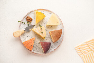 a plate of assorted cheese of different colors, close-up, top view