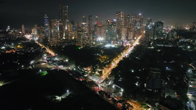 Timelapse of Central Mumbai's skyline at night. Aerial view of Mumbai lit up at night: Urban cityscape concept or abstract of advanced innovation, financial technology, and energy power. Worli, Dadar.