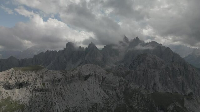 Drone footage of the rocky mountain peaks under a cloudy sky in Wolfenschiessen, Switzerland