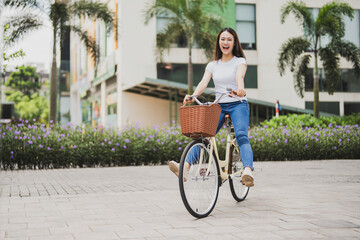 Photo of young Asian woman with bicycle