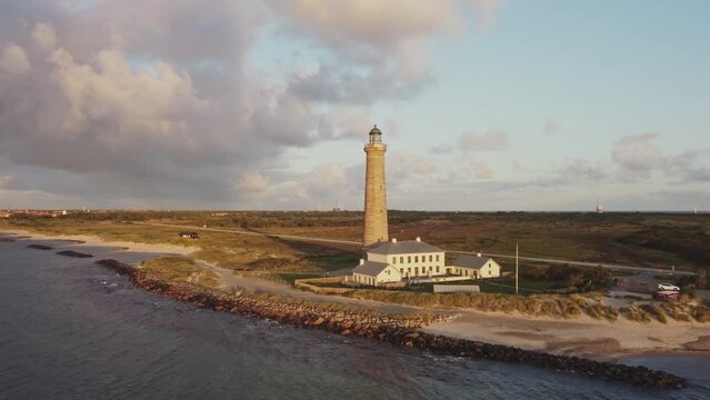Skagen Lighthouse During Sunset In The Far North of Jutland, Denmark. Aerial Arc Shot