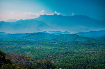A mountain Landscape with white cloud over green trees from Kerala, India