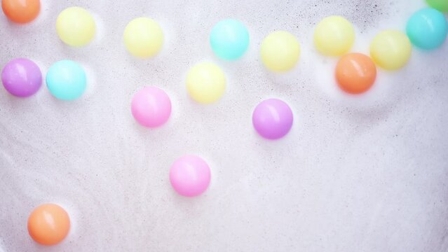 Background Of Colorful Small Plastic Balls Floating On Water. Soap Bubble And Colorful Plastic Ball.