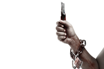 The hand of a scary zombie with blood and wounds holding a knife while tied to the iron chain