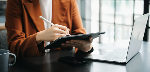 businesswoman hand working with new modern computer using on smartphone and tablet as concept.