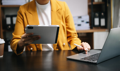 businessman working with digital tablet computer and smart phone with financial business strategy layer effect on desk