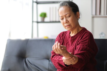 Senior woman with arm pain and wrist pain.