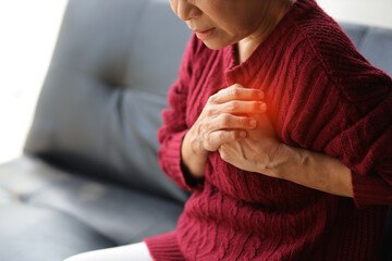 A senior woman has sudden chest pain in her home, heart disease and asthma patients. - obrazy, fototapety, plakaty