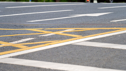 Yellow road markings close-up, waffle road markings at intersection, prohibition to enter intersection at red traffic light