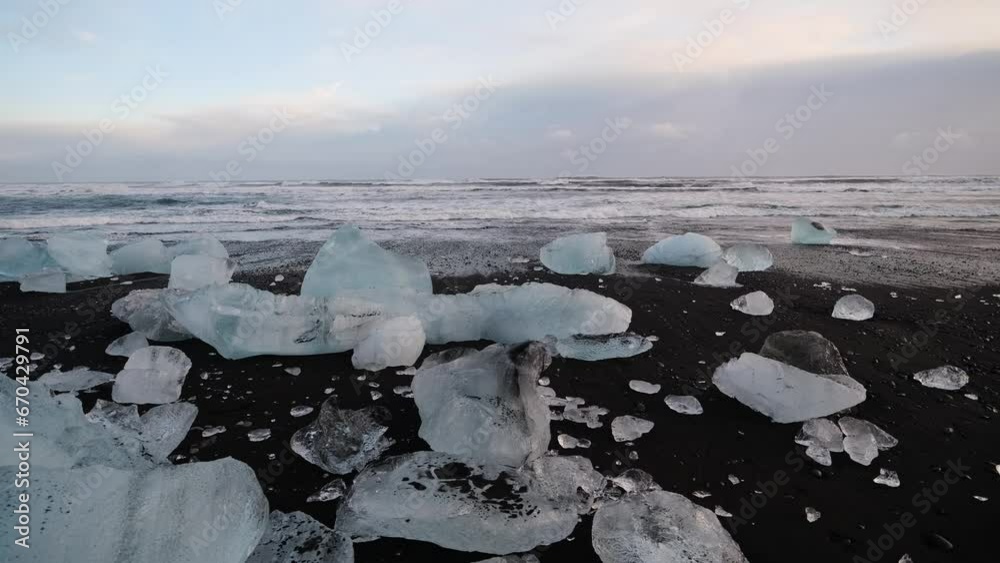 Wall mural diamond beach, iceland. pieces of icebergs with clear ice. reflections and light in the ice during s