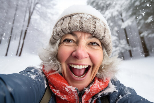 smiling mature woman taking a selfie on a snowy winter day
