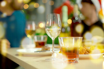 Group of diverse ethnicity young people enjoy celebrating a Christmas and New Year party together with a lot of foods and drinks. Friends celebrate Christmas and New Year festival and drink a wine.