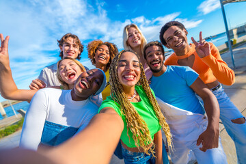 Multi-ethnic friends taking a selfie and smiling in the city