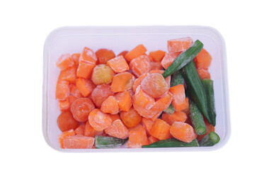 Frozen pieces of carrot, tomatoes and green okras in plastic box, isolated on white background. Concept, food preservation by freezing process for long lasting of food. Keep fresh and nutrients. 