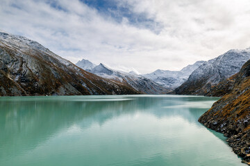 Mattmark reservoir in autumn with fresh snow