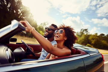 Happy smiling young couple driving vintage cabriolet car, going on the fun road trip together - obrazy, fototapety, plakaty