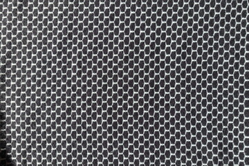 Surface of black and white jersey fabric with honeycomb pattern
