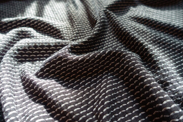 Crumpled black and white jersey fabric with geometric pattern