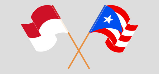 Crossed and waving flags of Indonesia and Puerto Rico