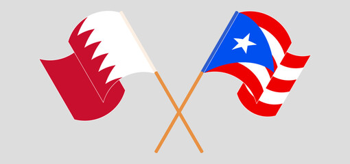 Crossed and waving flags of Bahrain and Puerto Rico