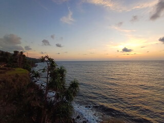 Sunset over the sea in the tropics. Beautiful sky. Photo taken from Cafe on the beach at Ternate...
