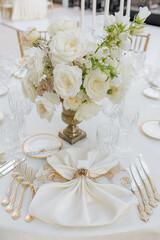 Vertical image of fragment of guest place of wedding table silverware,napkin with vintage ring . 