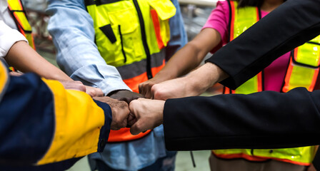 Fototapeta na wymiar Close up factory man and woman workers joined hands together for successful teamwork