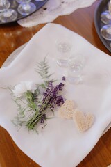 Traditions, symbols. Wedding tray with white napkin decorated with lavender, alcohol, baking 