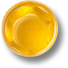 Close up view isolated of honey on plastic cup.