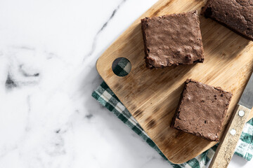 Chocolate brownie portions on marble background. Top view