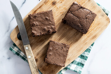 Chocolate brownie portions on marble background. Top view