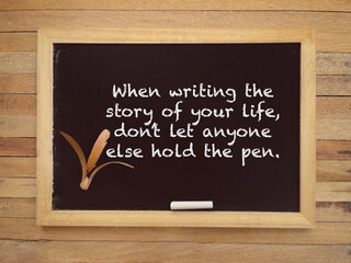 When Writing The Story Of Your Life, Don’t Let Anyone Else Hold The Pen written on a blackboard. With blurred styled background.