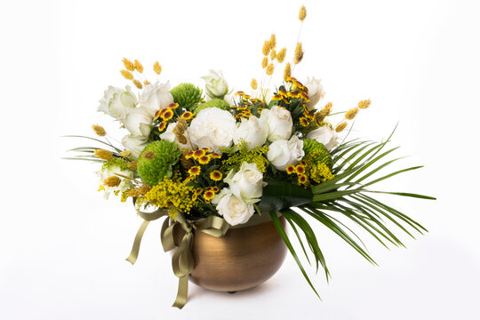 Magnificent bouquet of different flowers. Flower arrangement in vintage metal vase. table setting. yellow green white color