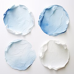 Naklejka premium four pieces of paper that have crumples and blue white spots on them on a white background, circular abstraction, light azure, light white and light azure four different sheets