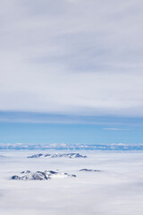 Fototapeta na wymiar Mountain tops between clouds view from top of Mount Titlis at 3020 meters altitude in Engelberg Switzerland
