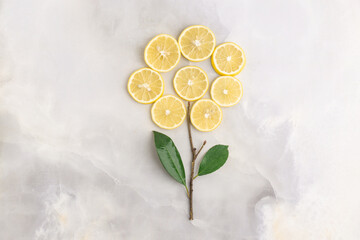 Composition of delicious citrus fruit and green leaves on grey background