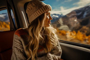 Fotobehang beautiful girl rides in a car in the mountains in winter, traveling on vacation © КРИСТИНА Игумнова