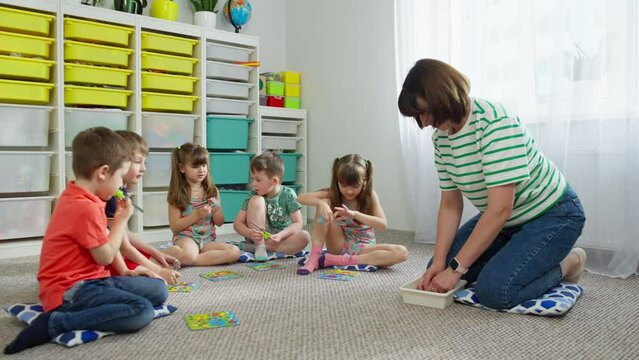 Pupils and the teacher play developmental games in primary school. smart generation logical lessons in the classroom smiles of children. High quality 4k footage