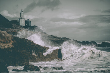 Immerse yourself in the dramatic beauty of Mumbles Lighthouse, where powerful waves crash against...