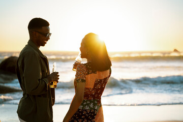 A Couple Having Sundowners At The Beach