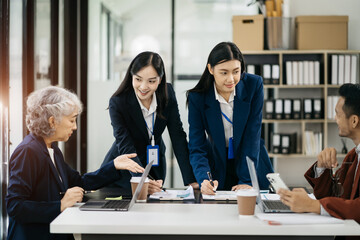 Businessman working as a team start meeting the new marketing project plan By business people using tablets and graph documents Calculate the amount of money for the project.