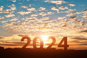 Silhouette of Happy new year 2024 in sunset or sunrise background.