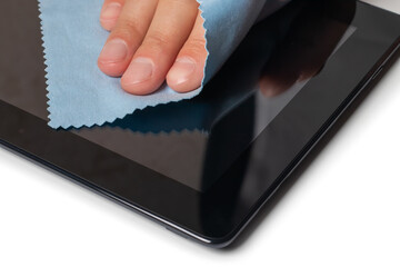 Man's Hand Cleaning Digital Tablet Screen With Soft Blue Cloth
