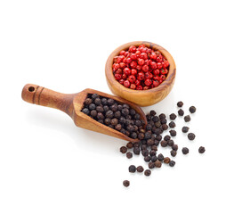 Black pepper in wooden spoon and peppercorn in wooden bowl isolated on white background