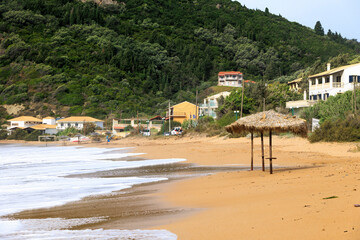 The sandy beach of Agios Georgios on the island of Corfu on a stormy day with high waves