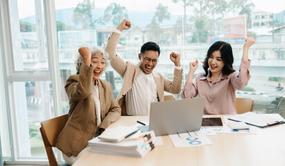 Happy businesspeople while collaborating on a new project in an office. Group of diverse businesspeople using a laptop and tablet